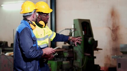Team multiracial colleague, professional industrial engineer and technician, worker wearing safety uniform, glasses, hard hat, using tablet discuss, analysis, process control in manufacturing factory.