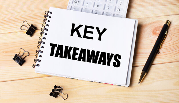Blank notepad with text KEY TAKEAWAYS, pen, calculator and paper clips on office wooden table.