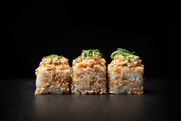 Sushi rolls on black slate board
