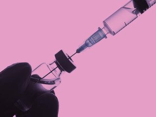 Doctor hand in gloves hold syringe and vaccine bottle on white background. Health and medical concept