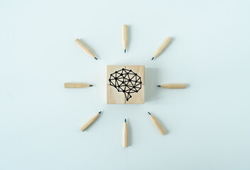 Wooden cube and pencil with brain icon. Business working or learning idea or education knowledge...