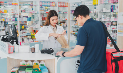 female pharmacist at drugstore.Health care pharmacists work at the hospital.Pharmacist looking at male customer.Doctor specialists organize prescription medications.The customer pay for medicines 