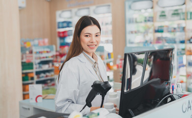 Female pharmacist running a drugstore business.The smiling doctor has confidence in health care.Pharmacy career selling medical products.