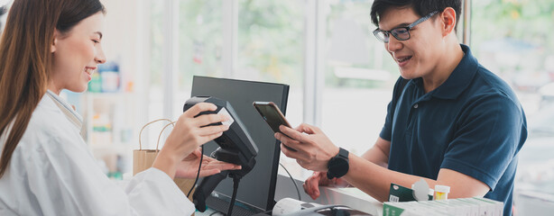 The customer pay for medicines with the pharmacy.Pharmacist looking at male customer.Doctor...