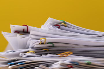 Stack of Group report papers Document on yellow background.