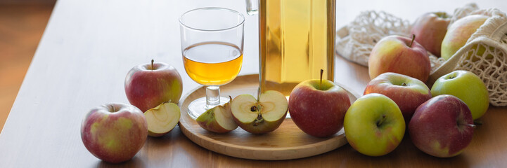 Fresh homemade organic apple juice or cider on a wooden table in a glass jug. Banner copy space