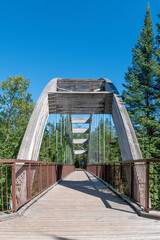 A wooden footbridge crosses a smaller section of Ouimet Canyon north of Lake Superior, joining to...