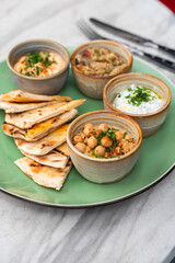 Snacks: hummus with sauce, eggplant caviar, Tzadziki- healthy and tasty food.