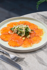 Salmon slices on plate with herbs. Selective focus.