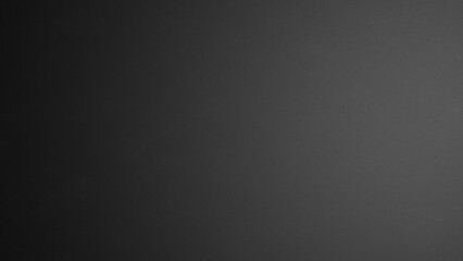 Black matte plastic background with texture and lighting.