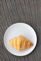Fresh delicious breakfast morning with Coffee, food croissants on brunch plate, jam on dark grunge wooden background. continental breakfast captured on above table top view flat lay.