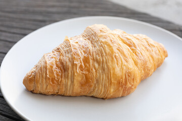 Fresh delicious breakfast morning with Coffee, food croissants on brunch plate, jam on dark grunge wooden background. continental breakfast captured on above table top view flat lay.