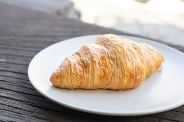 Fresh delicious breakfast morning with Coffee, food croissants on brunch plate, jam on dark grunge wooden background. continental breakfast captured on above table top view flat lay.