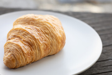 Fresh delicious breakfast morning with Coffee, food croissants on brunch plate, jam on dark grunge wooden background. continental breakfast captured on above table top view flat lay.