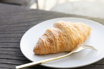 Fresh delicious breakfast morning with Coffee, food croissants on brunch plate, jam on dark grunge wooden background. continental breakfast captured on above table top view flat lay.