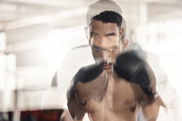Boxing, sports and fitness with motion blur and a man boxer training in a gym for health and...