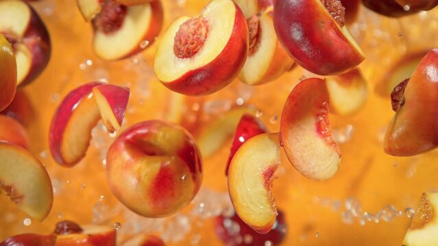 Super Slow Motion Shot of Peach Cuts And Water Flying Towards Camera on Orange at 1000 fps.