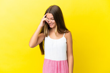 Little caucasian girl isolated on yellow background laughing