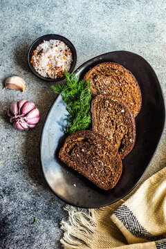 Overhead view of toasted rye bread with garlic and sea salt
