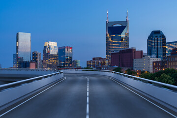Plakat Empty urban asphalt road exterior with city buildings background. New modern highway concrete construction. Concept of way to success. Transportation logistic industry fast delivery. Nashville. USA.