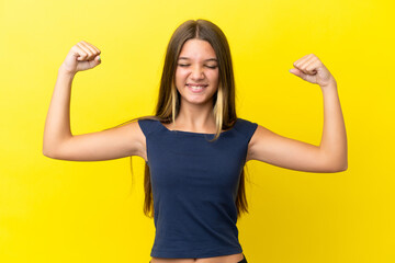 Little caucasian girl isolated on yellow background doing strong gesture