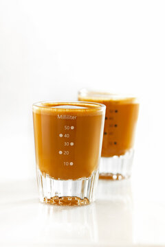 Two shots of coffee with milk