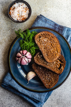 Overhead view of toasted rye bread with garlic and sea salt