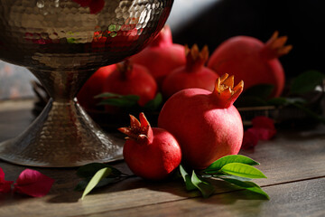 Pomegranates on a wooden table, the symbol of the Jewish new year - Rosh Hashanah. Dark background