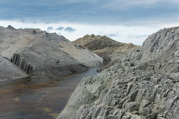 Fototapeta na wymiar coastal cliffs formed by columnar basalt at low tide
