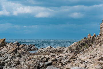 sharp jagged basalt rocks on the sea coast