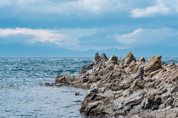 sharp jagged basalt rocks on the sea coast