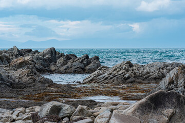 Fototapeta na wymiar sharp jagged basalt rocks on the sea coast