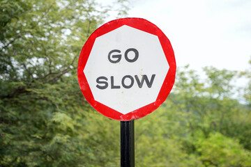 Go Slow sign Board on the road