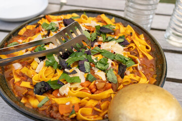 yellow pasta with orange tomato sauce and parmesan cheese 