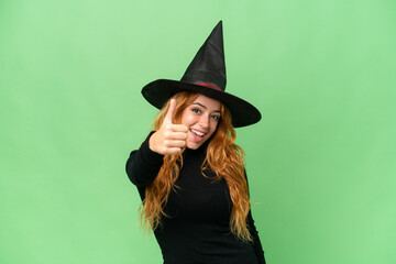 Young caucasian woman costume as witch isolated on green screen chroma key background with thumbs...