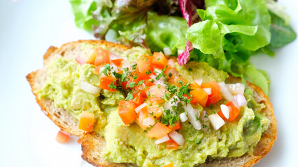 Healthy toast with smashed avocado, chopped tomatoes