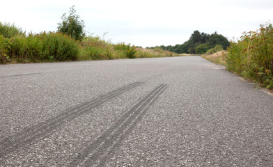 Fototapeta na wymiar Auto tire rubber on the asphalt