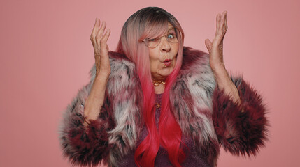 What Why. Sincere irritated elderly woman raising hands in indignant expression asking reason of...