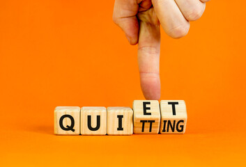 Quiet quitting symbol. Concept words Quiet quitting on wooden cubes. Businessman hand. Beautiful...