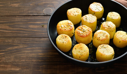 Fondant potatoes in frying pan