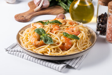 Italian pasta spaghetti with soft cheese sauce with shrimp or prawns on a plate