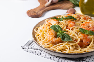 Italian pasta spaghetti with soft cheese sauce with shrimp or prawns on a plate