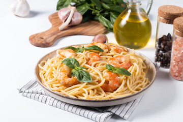 Italian pasta spaghetti with soft cheese sauce with shrimp or prawns on a plate