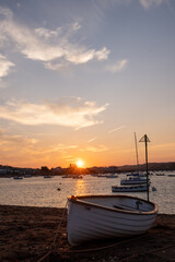 A rowing boat moored on Teignmouth's 'Back Beach' at sunset.