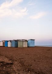 Obraz na płótnie Canvas Beach Huts On Teignmouth's Back Beach At Sunset