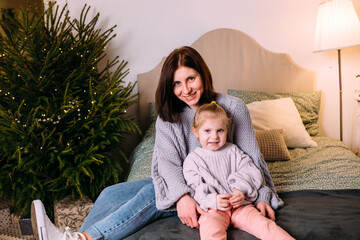 Mother and daughter having fun and relaxing at home. Xmas and New Year concept