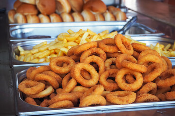 Onion rings and french fries, fast street food.