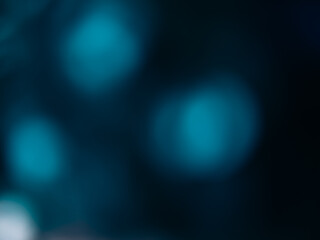 Bokeh light flare. Blur glow overlay. Optical radiance. Defocused blue color glare circles texture on dark night black abstract copy space background.