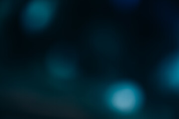 Bokeh glow overlay. Light flare texture. Blur flash spots. Defocused blue radiance on dark black...