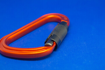Lightweight aluminium carabiners on a blue background. Strong connectors for climbing close-up